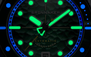 A macro lume shot of a diver watch