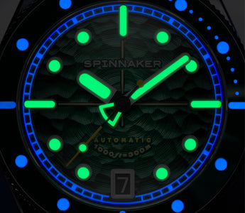 A macro lume shot of a diver watch