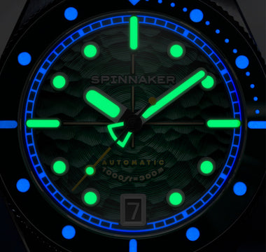 A macro lume shot of a diver watch
